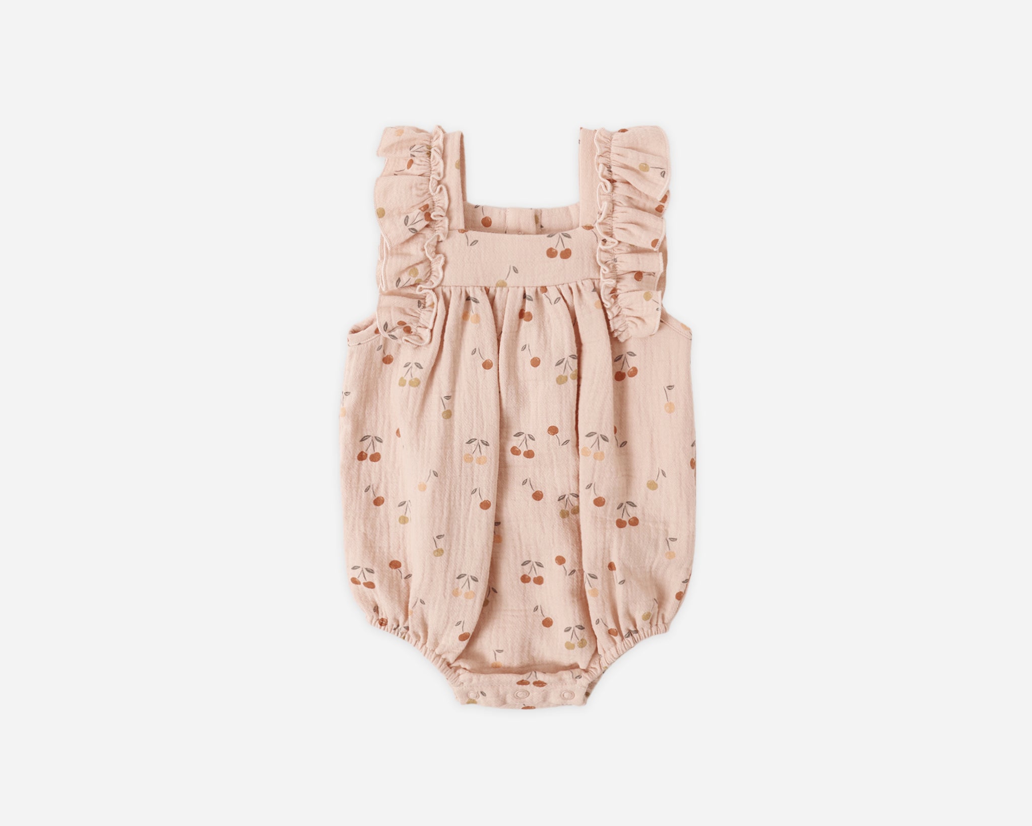 Rylee & Cru Ruffle Romper in Cherries, a blush pink baby romper with a cherry print and ruffle sleeves