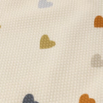 Close-up of the multicolor heart print on the Rylee & Cru Scoop Back One-Piece Swimsuit in Confetti Hearts