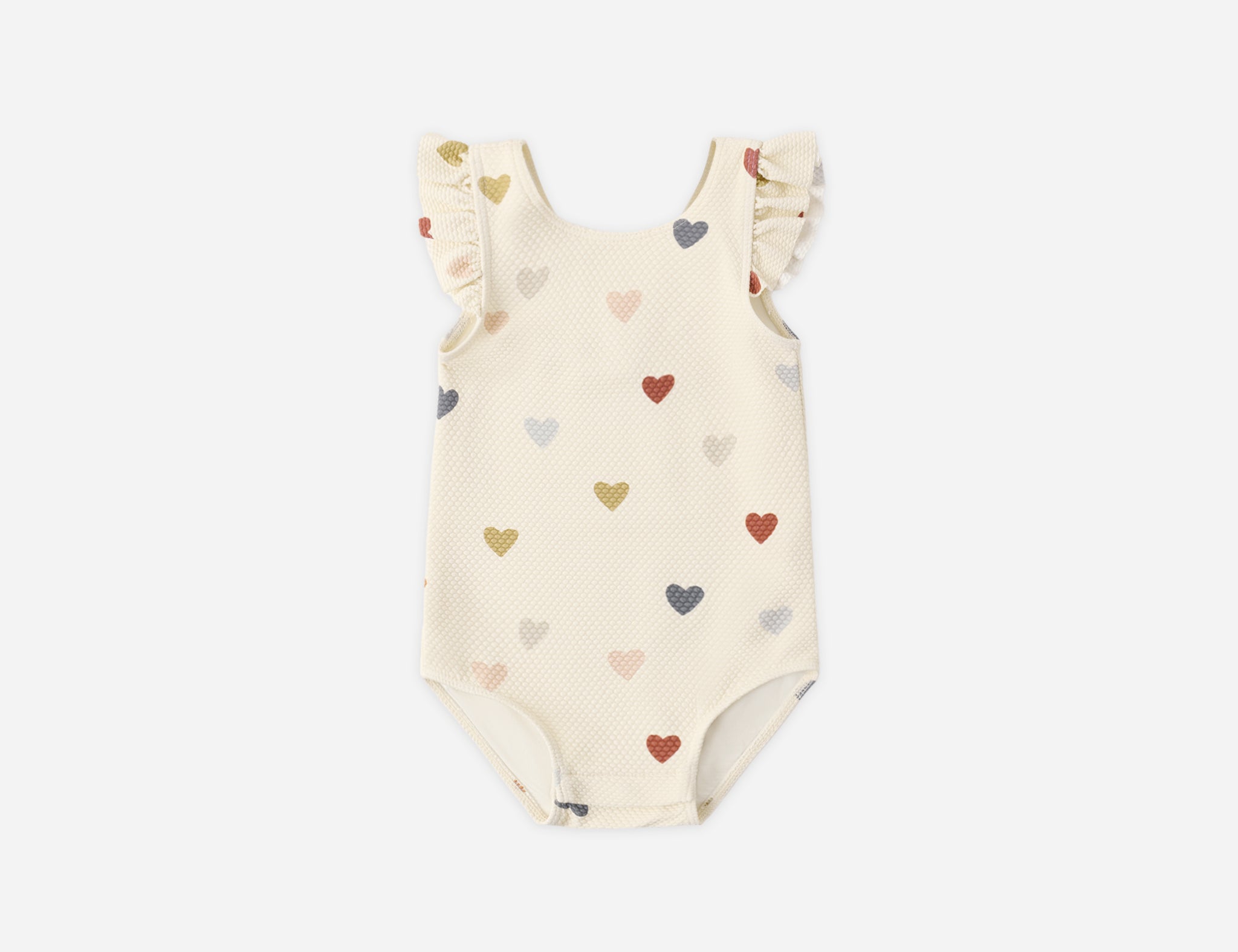 Rylee & Cru Scoop Back One-Piece Swimsuit in Confetti Hearts, a cream baby swimsuit with multicolor hearts and ruffle straps