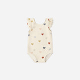 Rylee & Cru Scoop Back One-Piece Swimsuit in Confetti Hearts, a cream baby swimsuit with multicolor hearts and ruffle straps