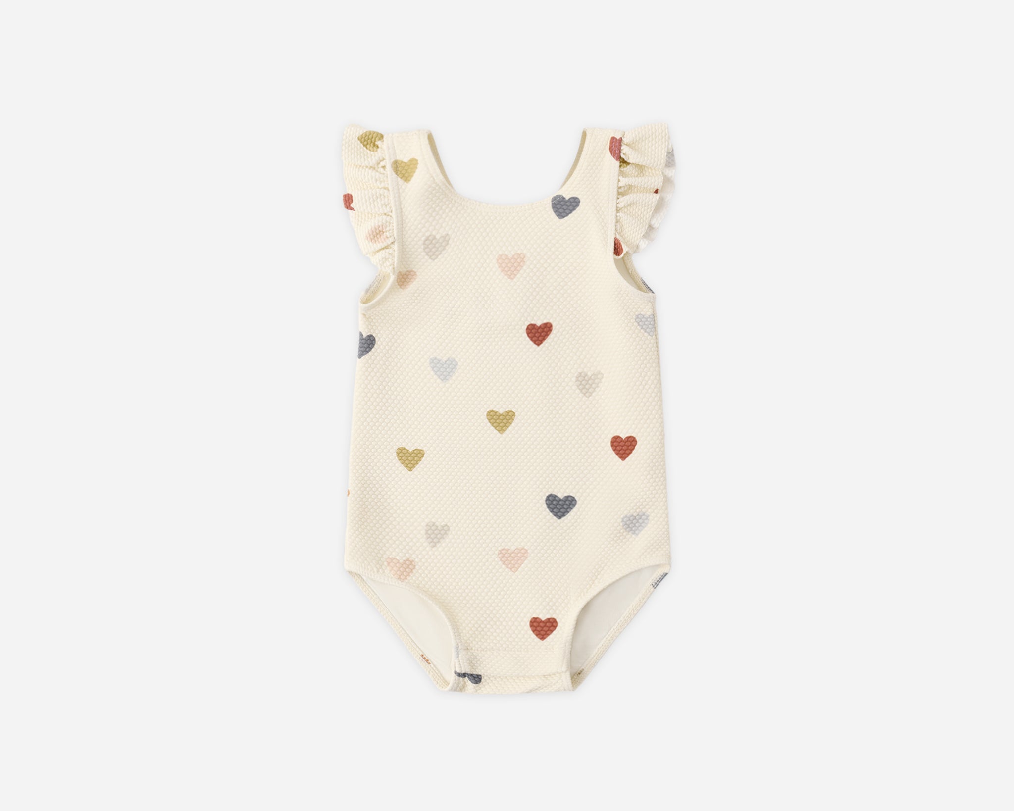 Rylee & Cru Scoop Back One-Piece Swimsuit in Confetti Hearts, a cream baby swimsuit with multicolor hearts and ruffle straps