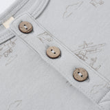 Close-up of the wooden buttons and airplane print on the Rylee & Cru Short Sleeve One-Piece in Airplanes