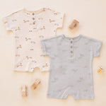 Rylee & Cru Short Sleeve One-Pieces in Race Car and Airplanes laid out with wooden toys