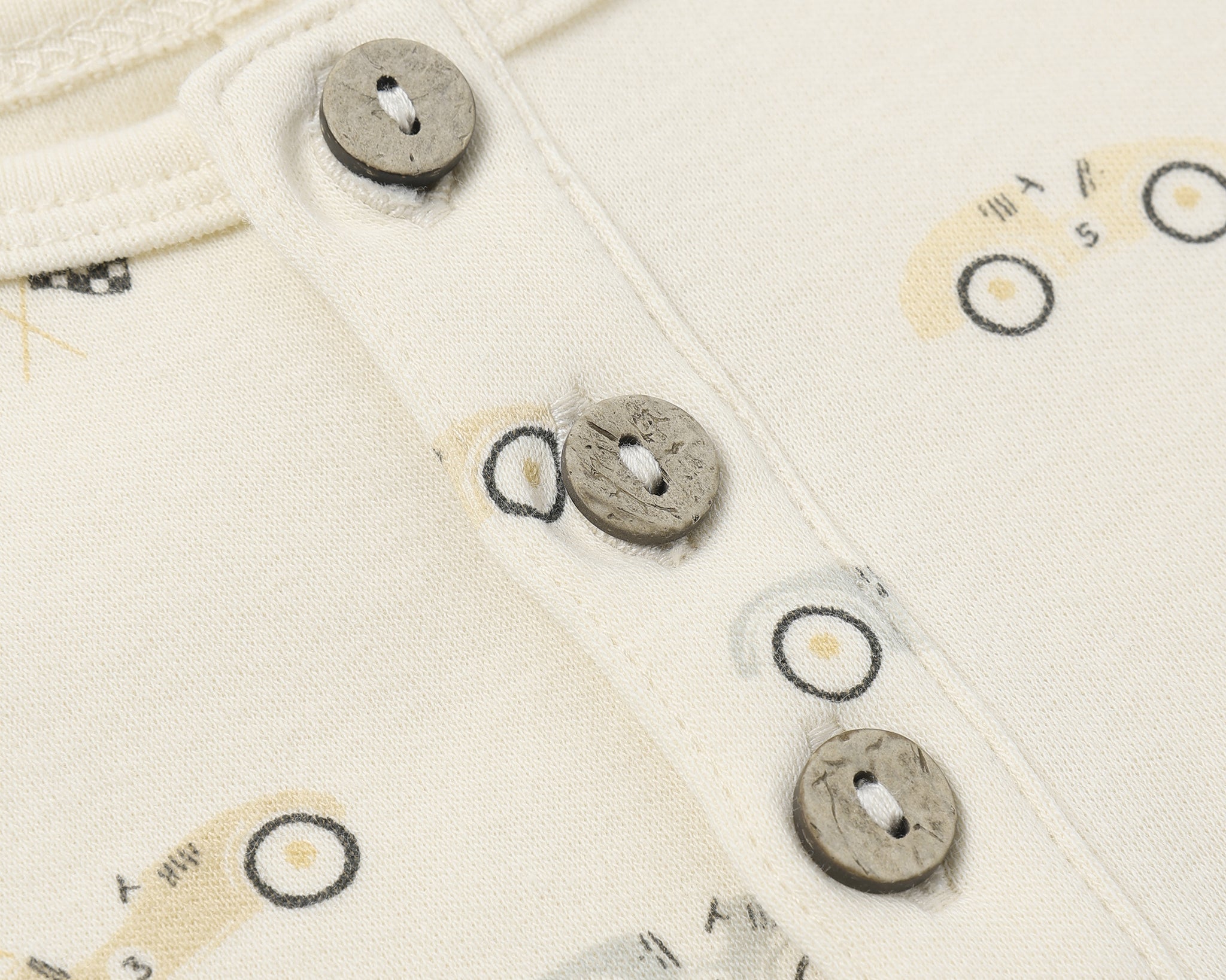 Close-up of the wooden buttons and race car print on the Rylee & Cru Short Sleeve One-Piece in Race Car