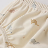 Close-up of the pastel dinosaur print and elastic waistband on the Rylee & Cru Swim Diaper in Dino