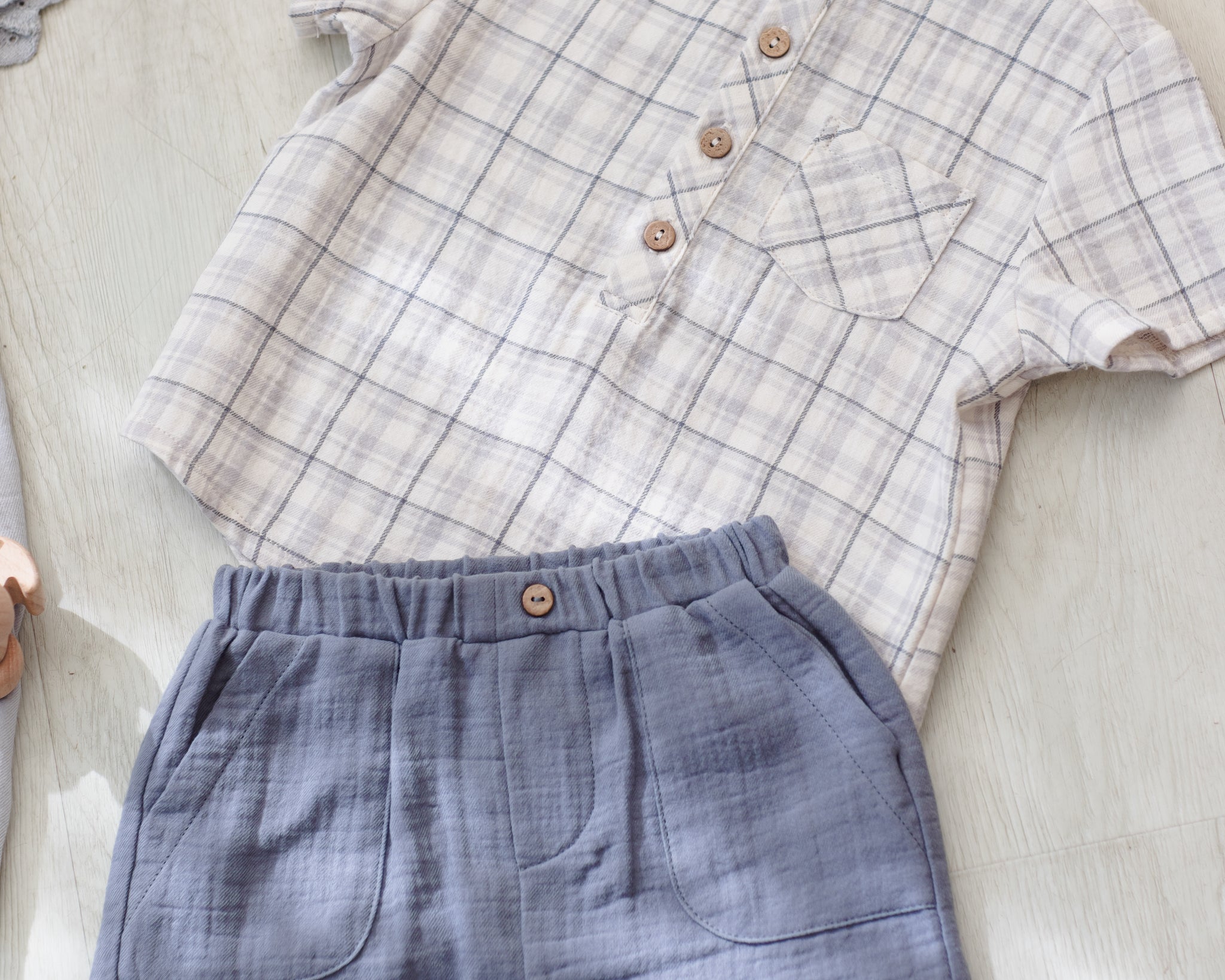 Rylee & Cru Utility Short in Ocean and a plaid shirt laid out as an outfit
