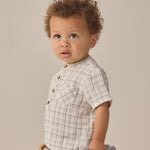 Toddler with curly hair in a plaid shirt and Rylee & Cru Utility Short, looking to the side