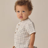 Toddler with curly hair in a plaid shirt and Rylee & Cru Utility Short, looking to the side