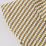 Close-up of the mustard and cream seersucker stripe fabric on the Rylee & Cru Youth Bucket Hat in Honey Stripe