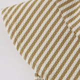 Close-up of the mustard and cream seersucker stripe fabric on the Rylee & Cru Youth Bucket Hat in Honey Stripe