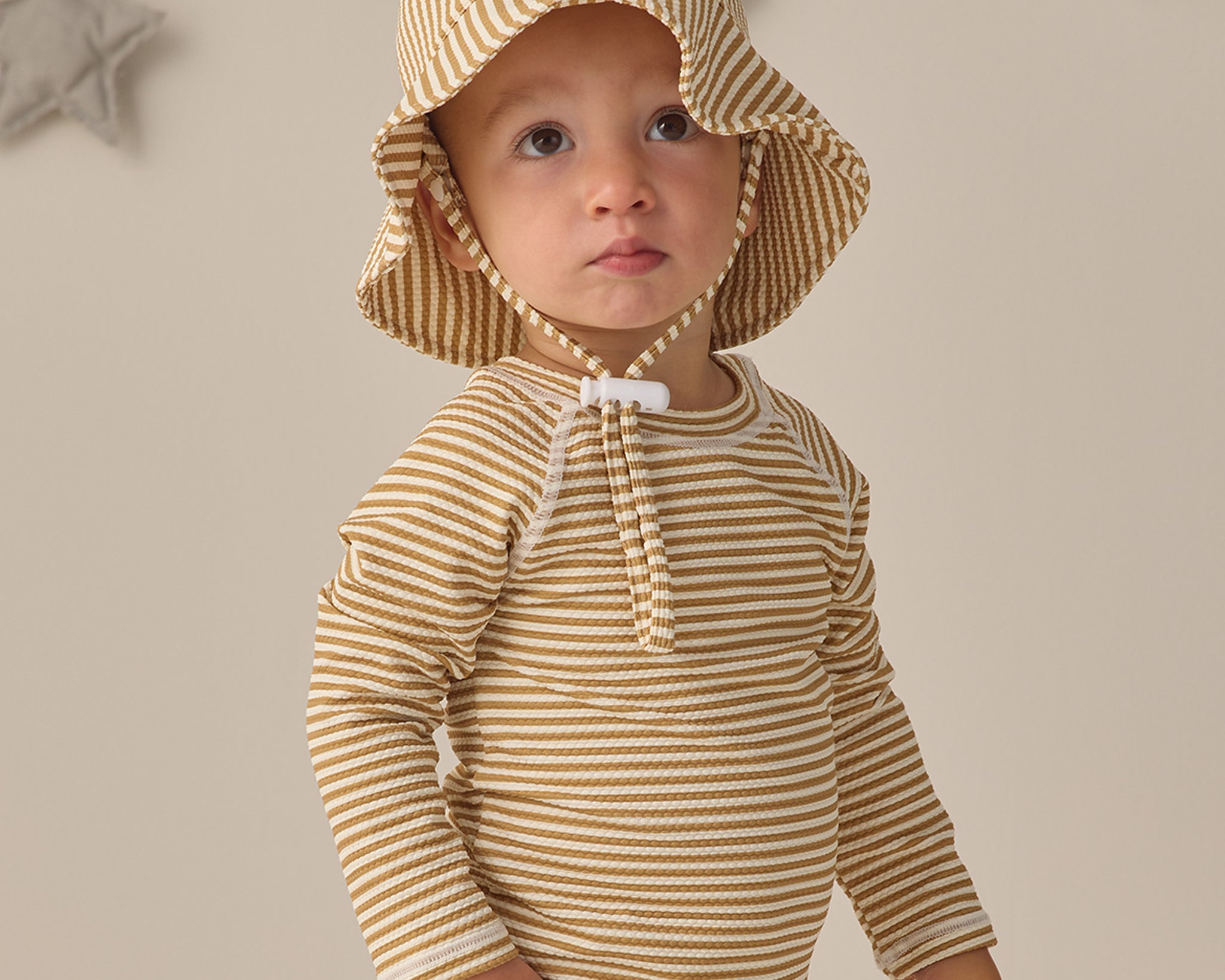 Toddler wearing the Rylee & Cru Youth Bucket Hat in Honey Stripe, front view