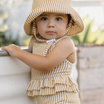 Baby wearing the Rylee & Cru Youth Bucket Hat in Marigold Stripe, front view