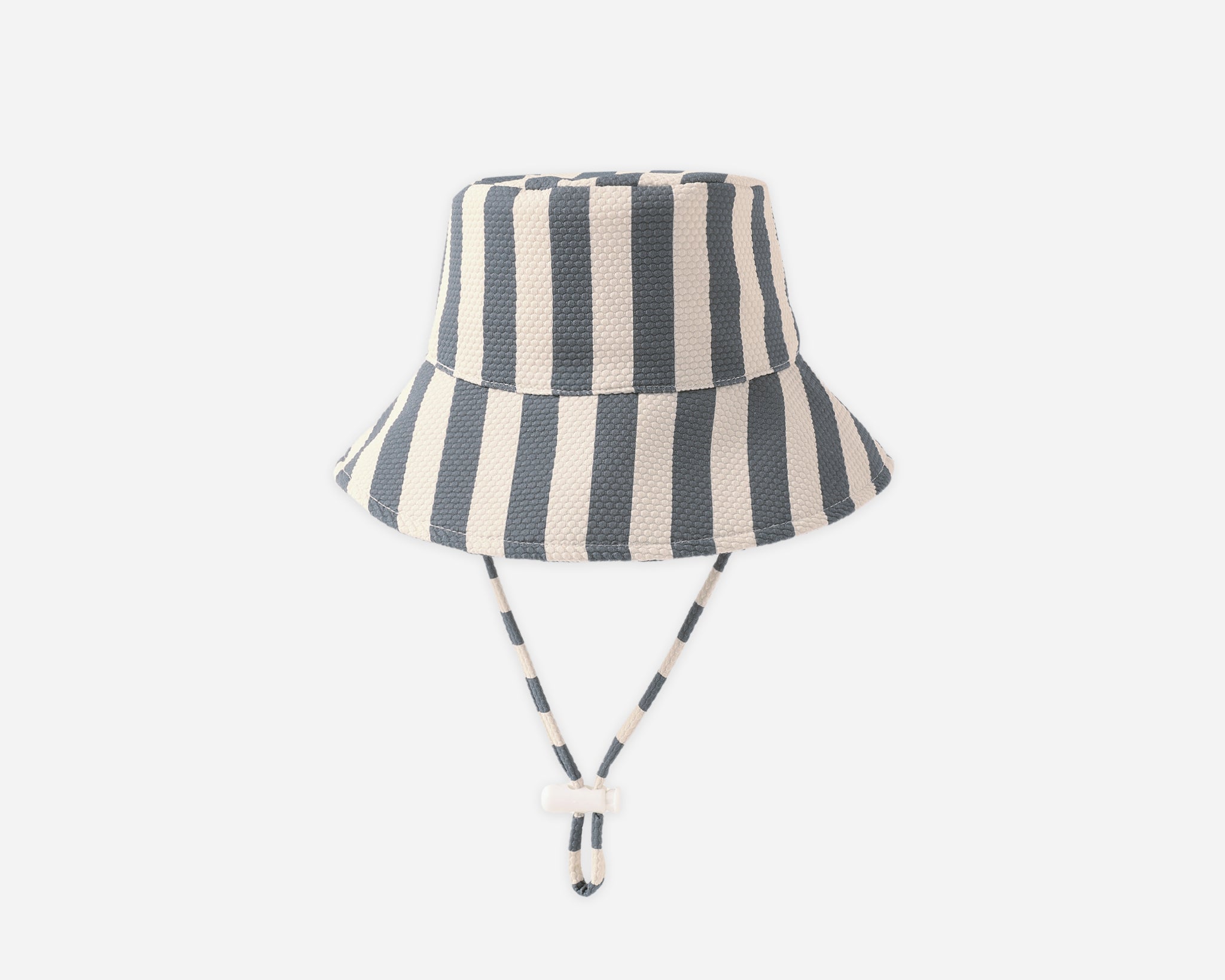 Rylee & Cru Youth Bucket Hat in Retro Stripe Ocean, a navy and cream striped bucket hat with chin ties