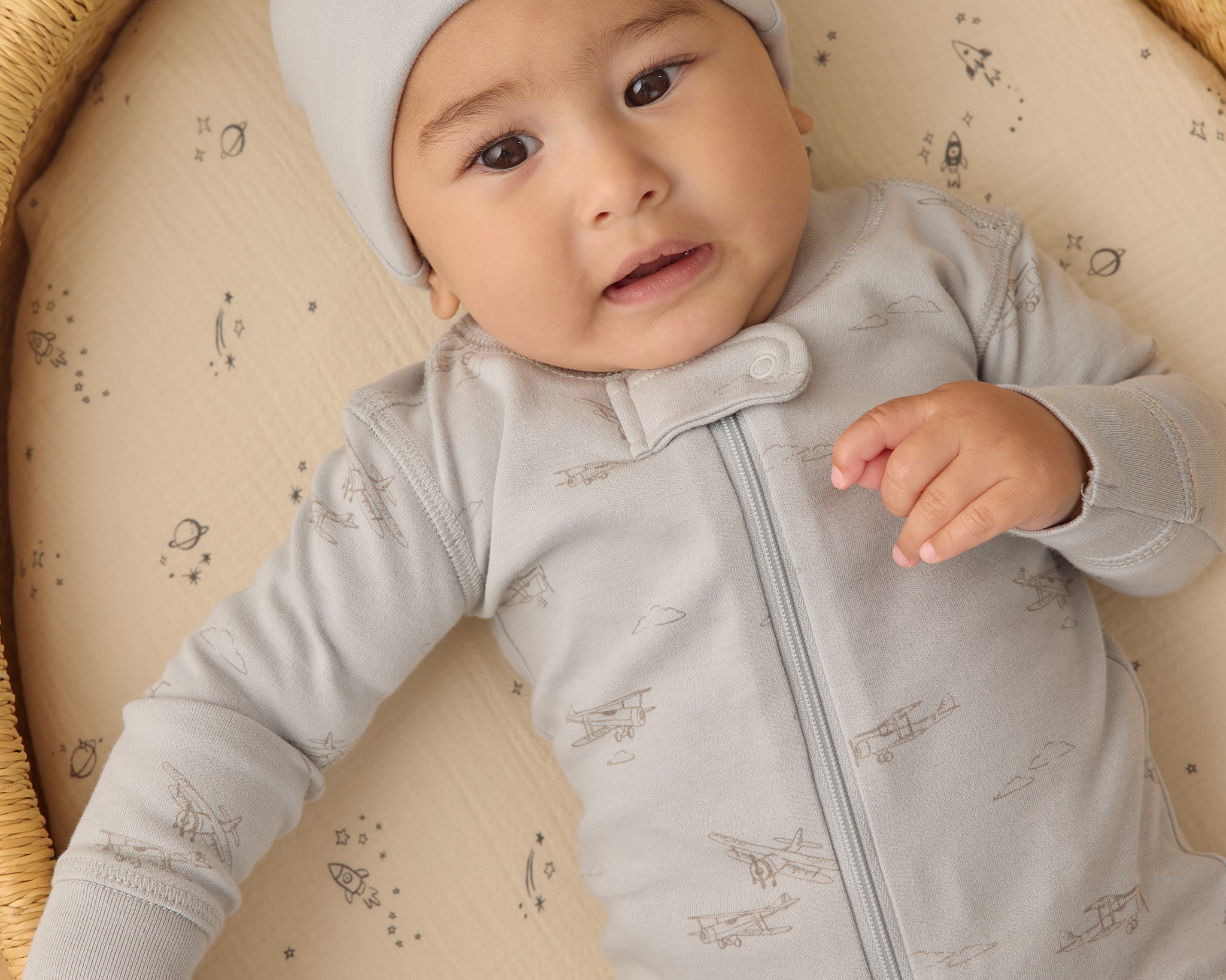 Baby wearing the Rylee & Cru Zip Longsleeve Sleeper in Airplane, close-up of the front zipper and light blue print
