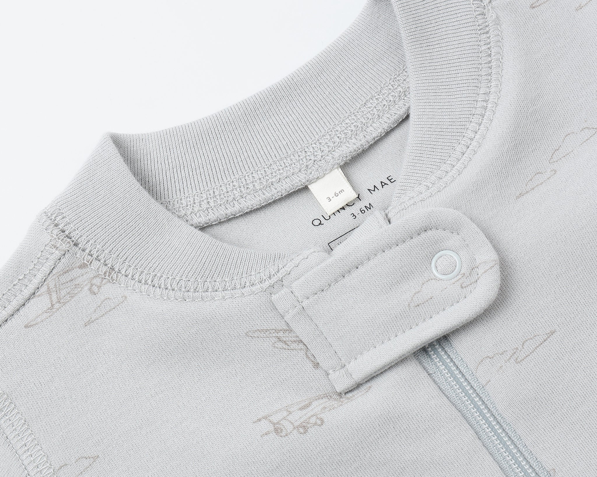 Close-up of the snap collar and zipper on the Rylee & Cru Zip Longsleeve Sleeper in Airplane