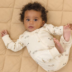 Baby stretched out on a quilt wearing the Rylee & Cru Zip Longsleeve Sleeper in Race Car