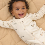 Smiling baby wearing the Rylee & Cru Zip Longsleeve Sleeper in Race Car, close-up