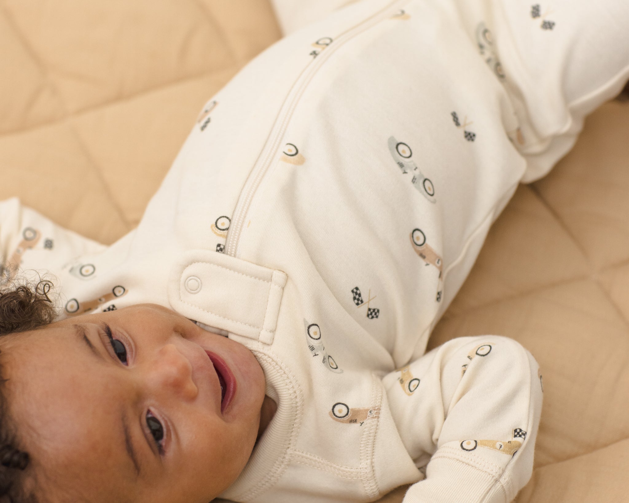 Baby wearing the Rylee & Cru Zip Longsleeve Sleeper in Race Car showing the front zipper