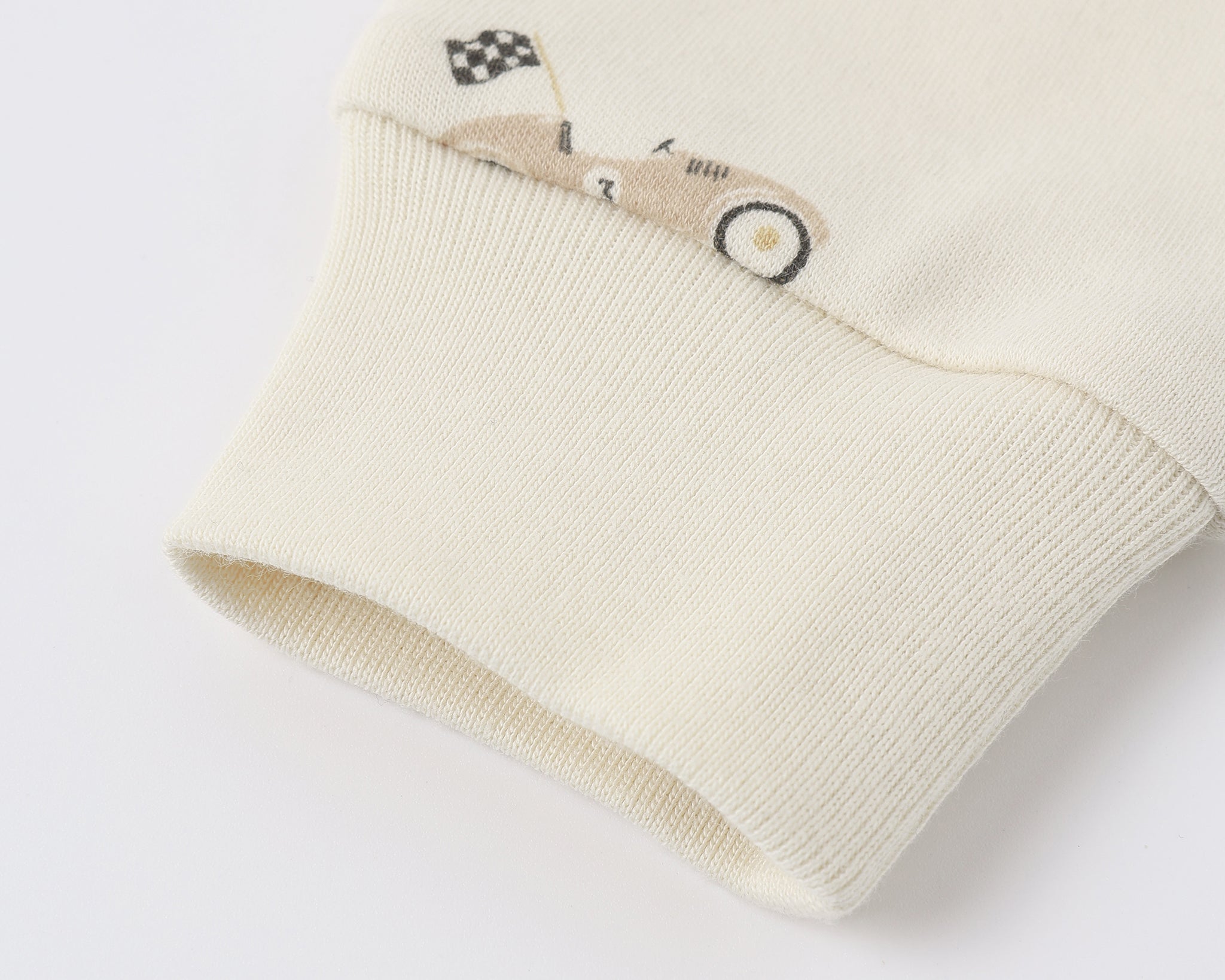 Close-up of the ribbed cuff and race car print on the Rylee & Cru Zip Longsleeve Sleeper in Race Car