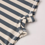 Close-up of the navy and cream textured stripe fabric on the Rylee & Cru Zip Rashguard One-Piece in Retro Ocean Stripe