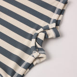 Close-up of the navy and cream textured stripe fabric on the Rylee & Cru Zip Rashguard One-Piece in Retro Ocean Stripe