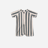 Rylee & Cru Zip Rashguard One-Piece in Retro Ocean Stripe, a navy and cream striped short-sleeve baby swimsuit with a front zipper