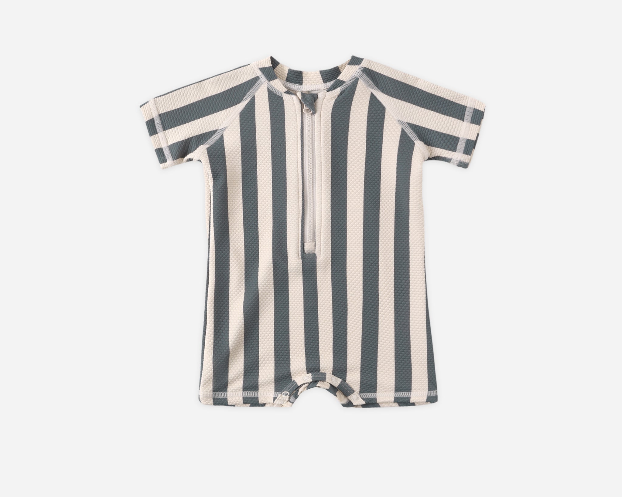 Rylee & Cru Zip Rashguard One-Piece in Retro Ocean Stripe, a navy and cream striped short-sleeve baby swimsuit with a front zipper