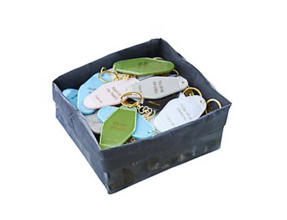 Santa Barbara Design Studio That's All Motel Key Tags in assorted colors in a black display box