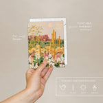 Hand holding the Seedlings Desert Moonlight card with its plantable seed paper envelope and instructions