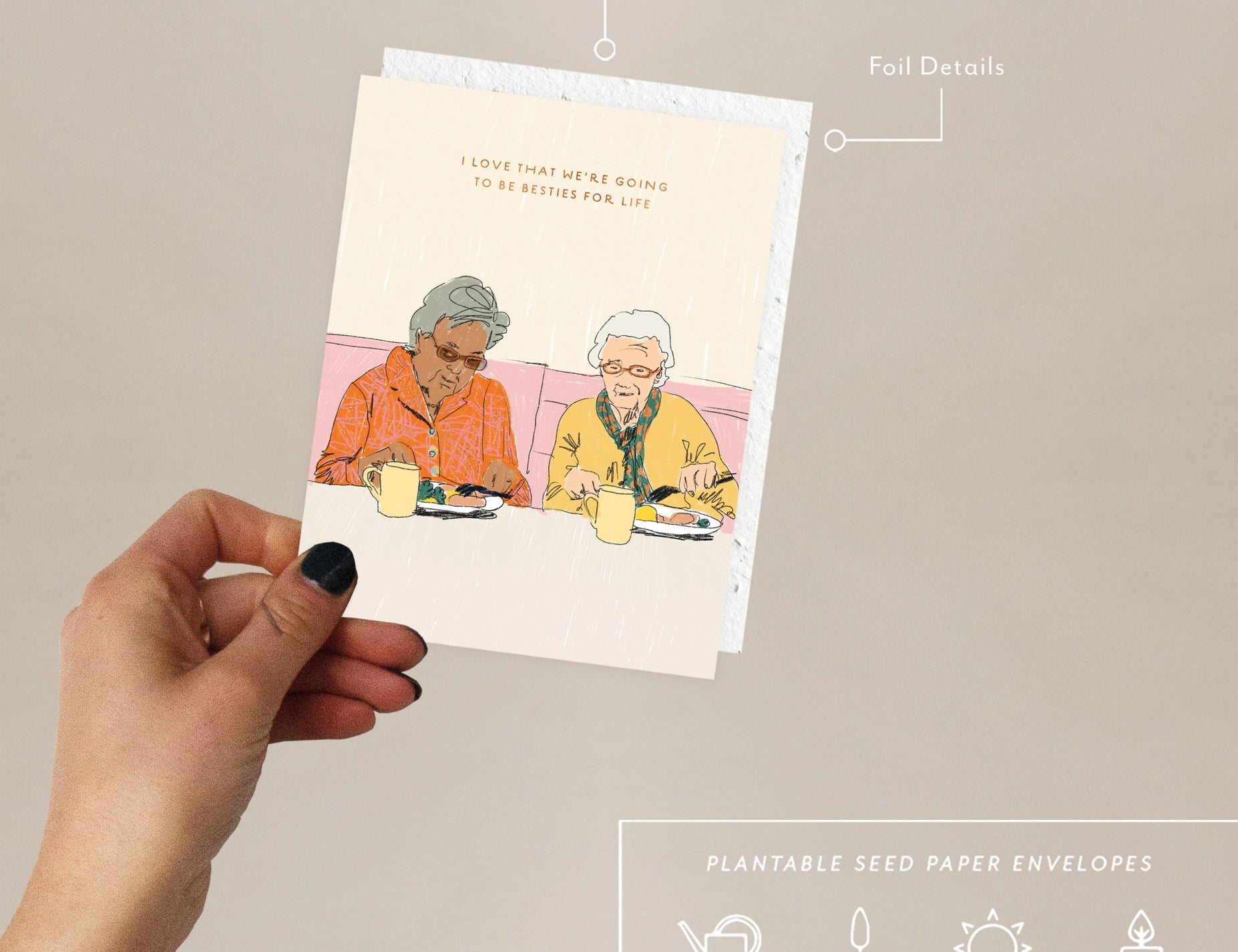 Hand holding the Seedlings Forever Friends card with its plantable seed paper envelope and instructions