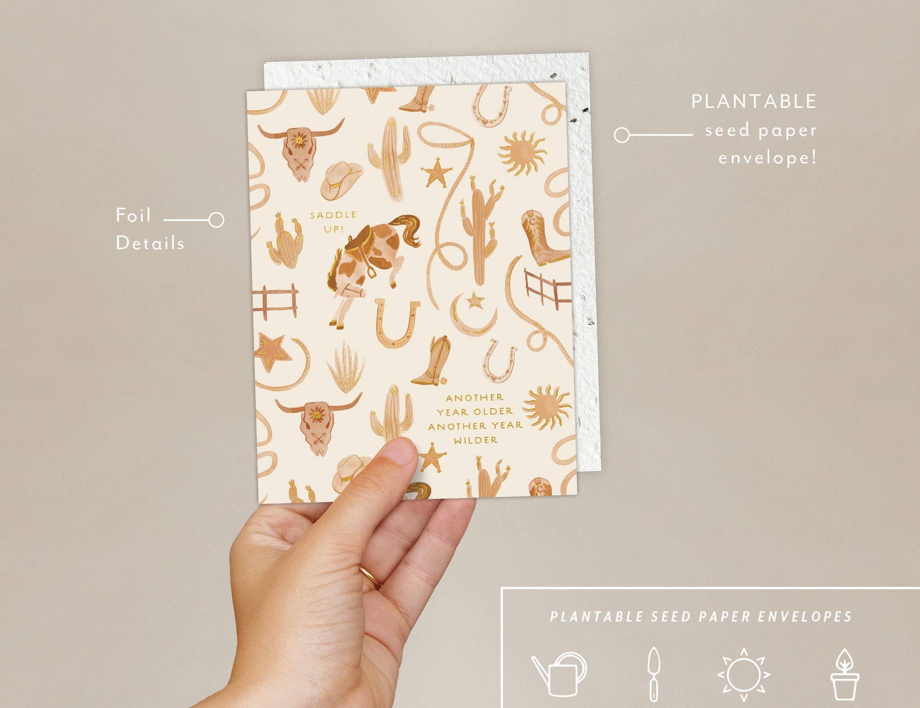 Hand holding the Seedlings Saddle Up Birthday Card with its plantable seed paper envelope and instructions