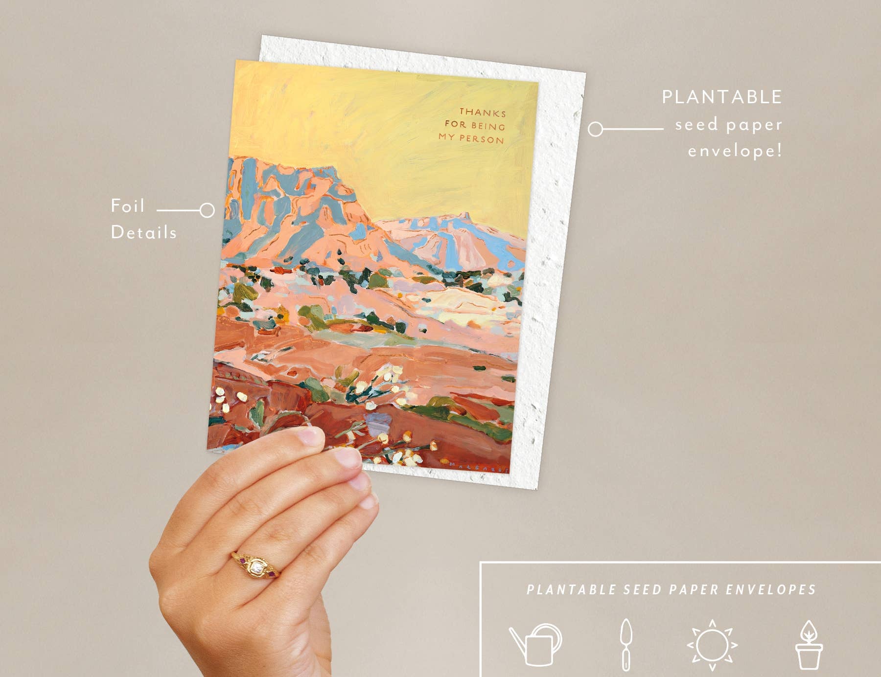 Hand holding the Seedlings Shadow Rocks card with its plantable seed paper envelope and instructions