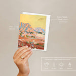 Hand holding the Seedlings Shadow Rocks card with its plantable seed paper envelope and instructions