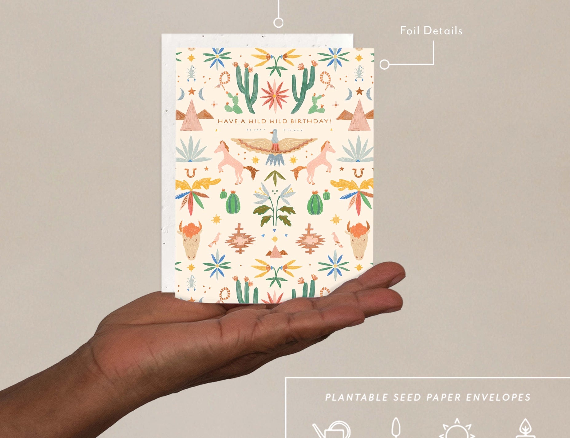 Hand holding the Seedlings Western Toile Birthday Card with its plantable seed paper envelope and instructions