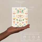 Hand holding the Seedlings Western Toile Birthday Card with its plantable seed paper envelope and instructions