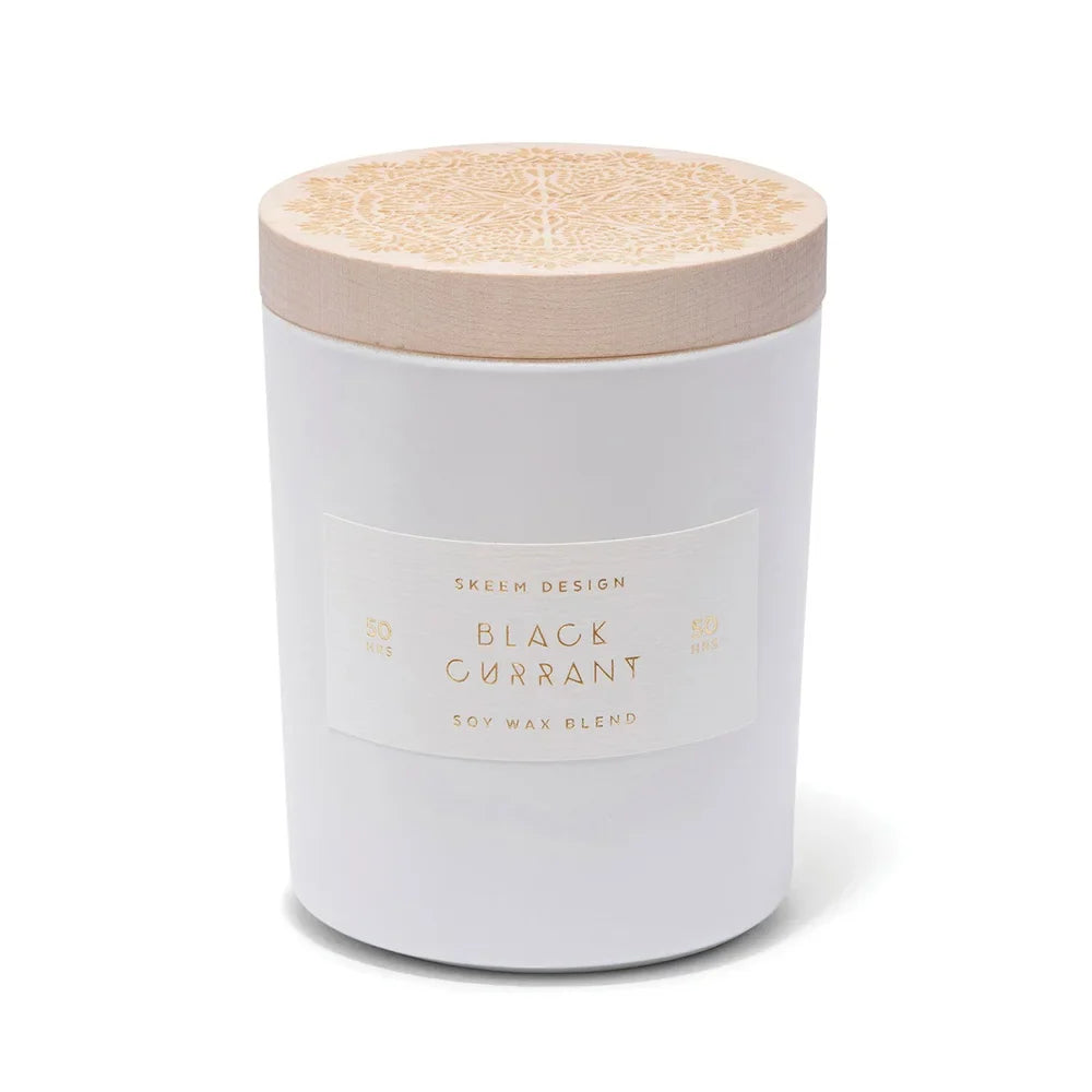 Skeem Black Currant Candle in a white glass jar with a natural wood lid