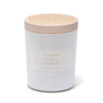 Skeem Black Currant Candle in a white glass jar with a natural wood lid