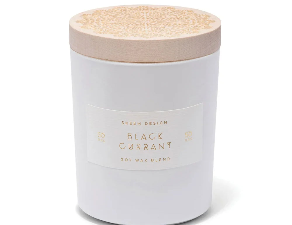 Skeem Black Currant Candle in a white glass jar with a natural wood lid