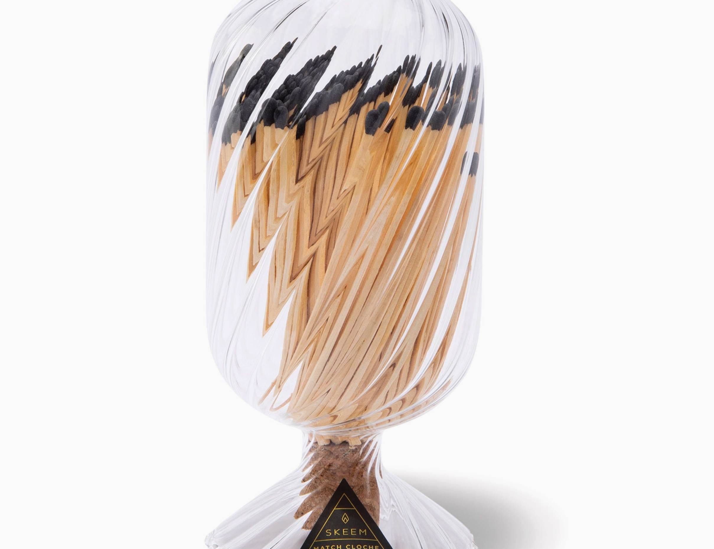 Skeem Helix Match Cloche, a twisted glass cloche filled with long matches on a metal base
