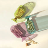 Skeem Match Cloches in violet, olive and amber lying on their sides from above