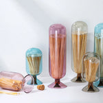 Skeem Match Cloches in aqua, plum, amber and gray standing together with loose matches