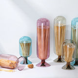 Skeem Match Cloches in aqua, plum, amber and gray standing together with loose matches