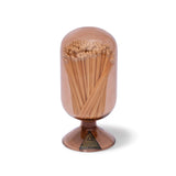 Skeem Match Cloche in Mushroom, a taupe glass dome filled with long matches on a footed base