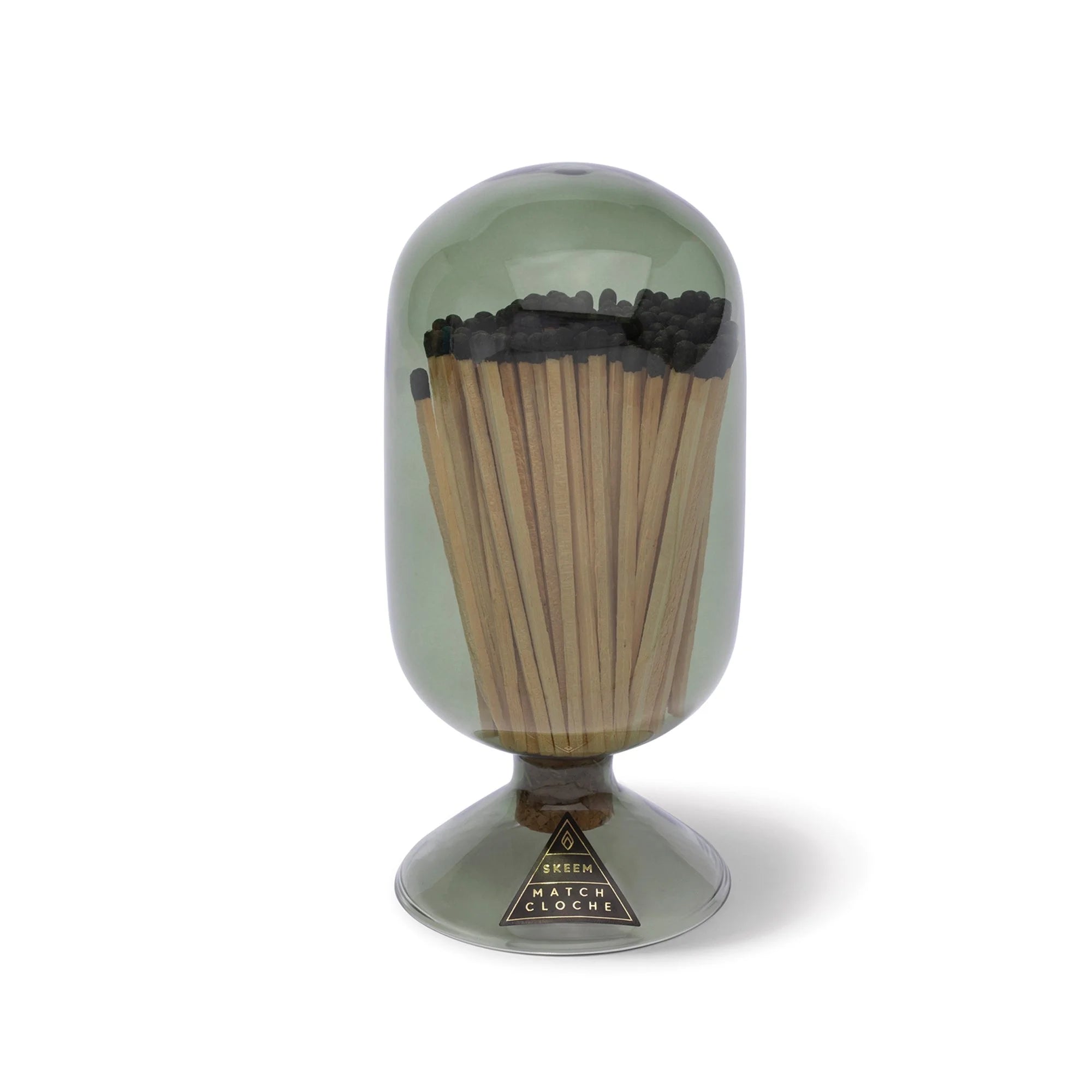 Skeem Match Cloche in Olive, a green glass dome filled with long matches on a footed base