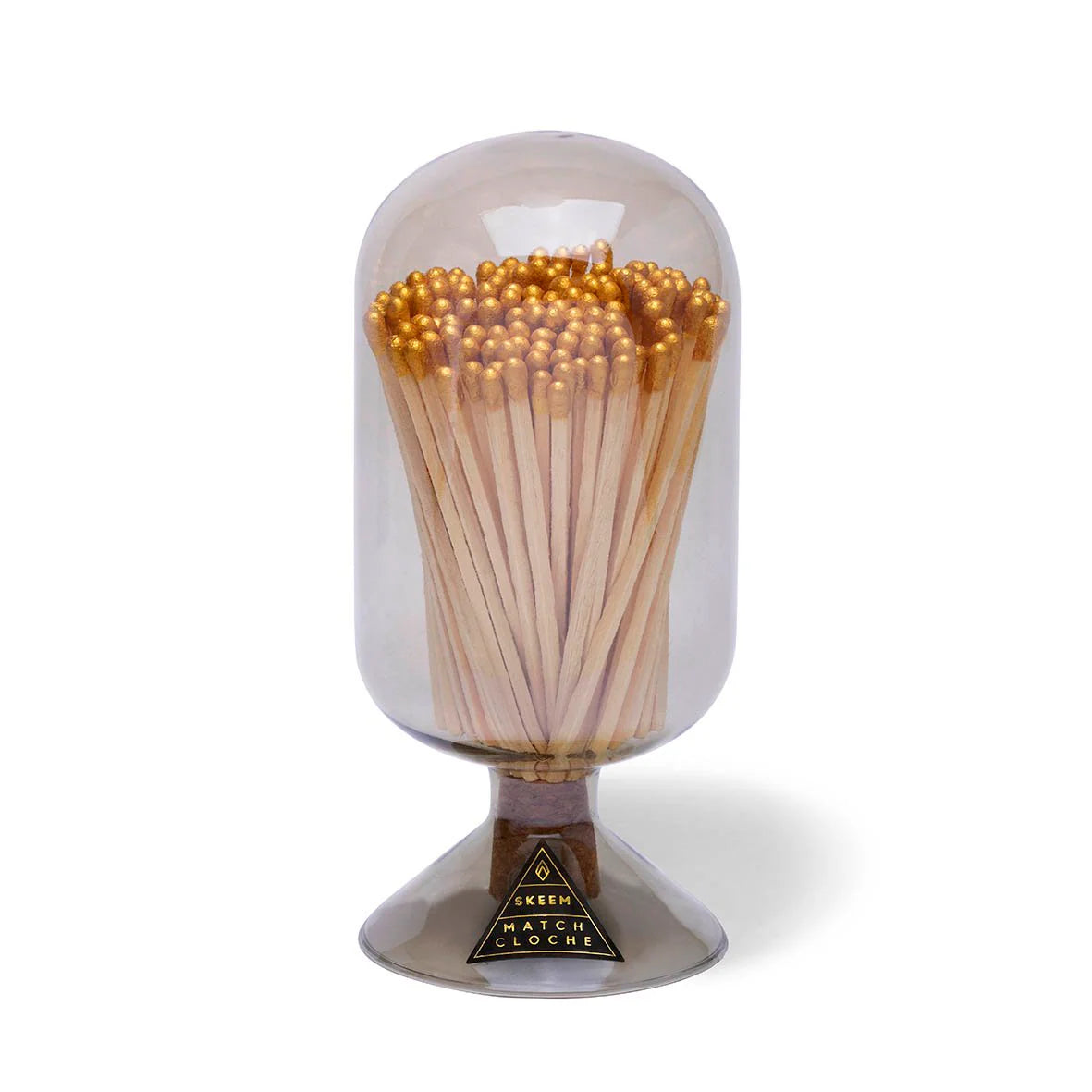 Skeem Match Cloche in Smoke, a gray glass dome filled with long matches on a footed base