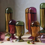 Skeem Match Cloches in olive, amber, plum and violet on a table with matches