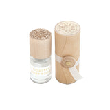 Skeem Print Block Perfume in Coastal Driftwood, a small rollerball bottle beside its carved wooden print block case