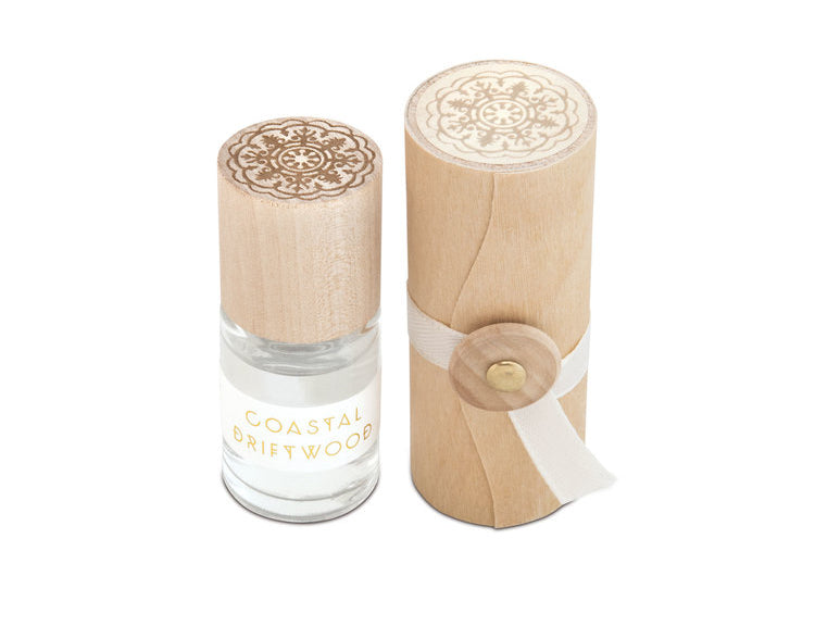 Skeem Print Block Perfume in Coastal Driftwood, a small rollerball bottle beside its carved wooden print block case