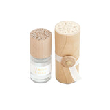 Skeem Print Block Perfume in Lemon & Oak, a small rollerball bottle beside its carved wooden print block case