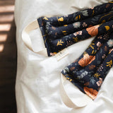 Slow North Hot + Cold Neck Wrap in Canyon Springs, navy floral print, folded on white bedding